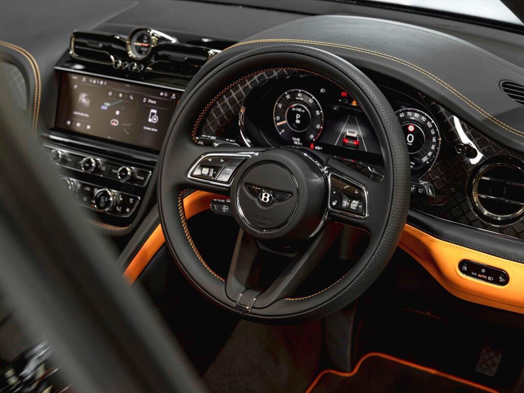An interior shot of the steering wheel on a 2025 Bentley Bentayga