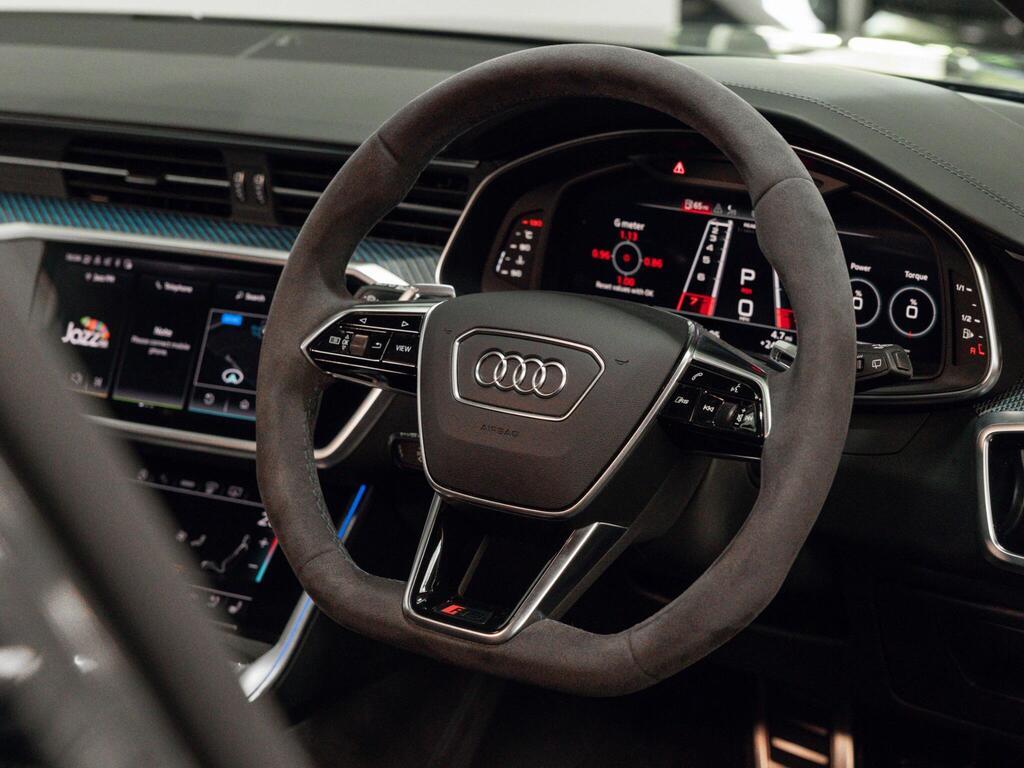 An interior shot of the steering wheel on a 2023 Audi RS6 Avant