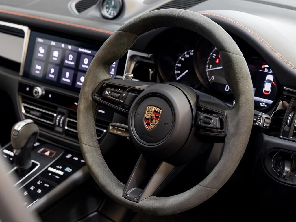 An interior shot of the steering wheel on a 2025 Porsche Macan