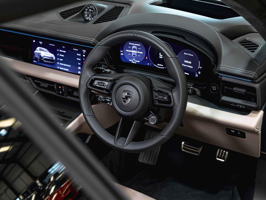 An interior shot of the steering wheel on a 2024 Porsche Macan