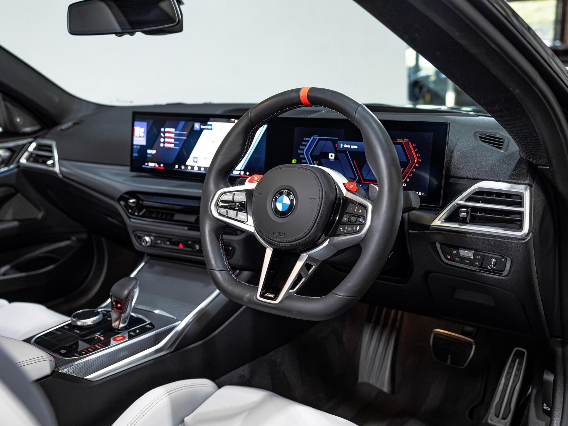 An interior shot of the steering wheel on a 2025 BMW M4