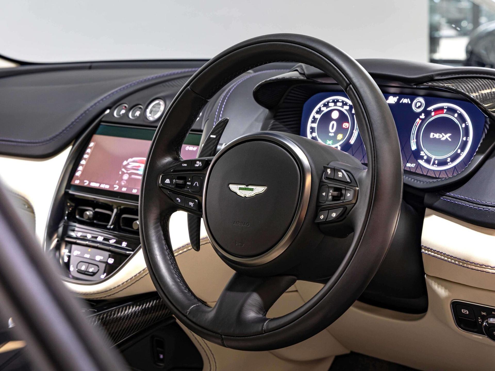 An interior shot of the steering wheel on a 2023 Aston Martin DBX