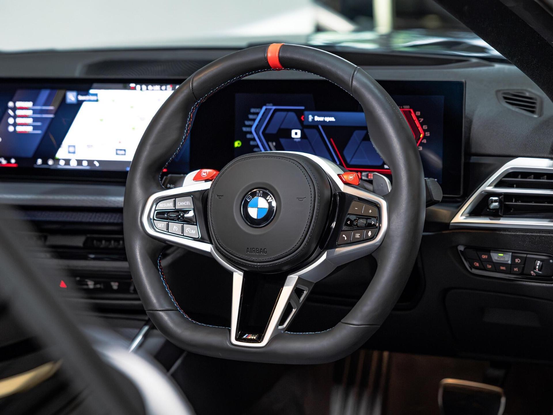 An interior shot of the steering wheel on a 2025 BMW M4