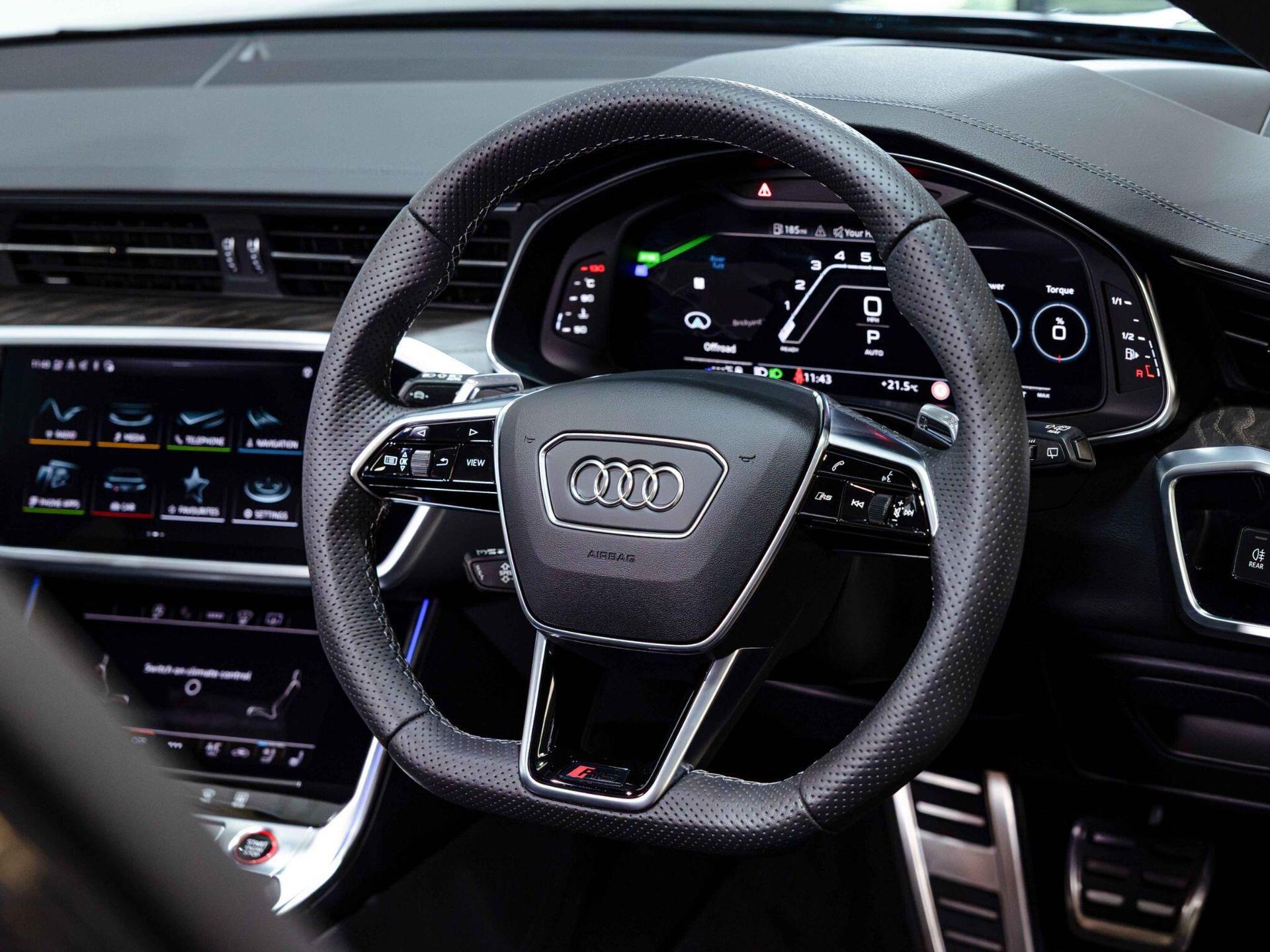 An interior shot of the steering wheel on a 2023 Audi RS6 Avant