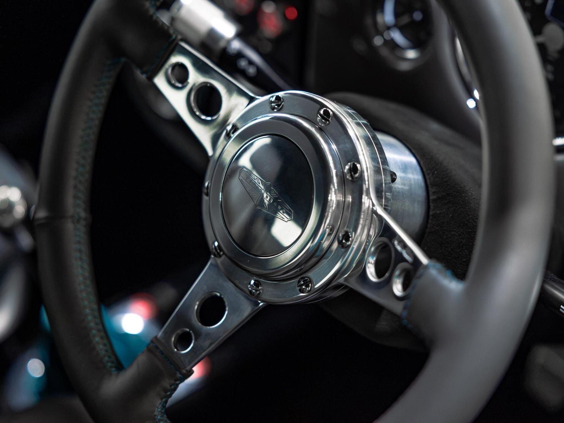 An interior shot of the steering wheel on a 1997 Rover Mini