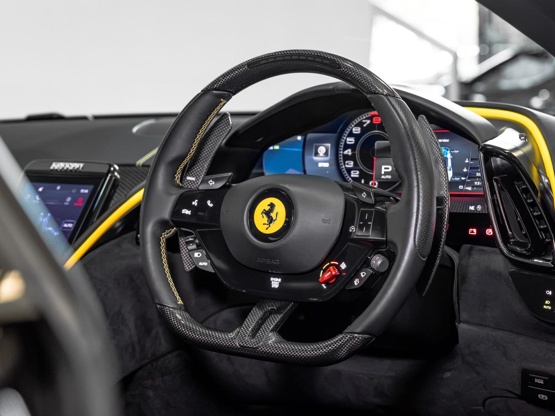 An interior shot of the steering wheel on a 2021 Ferrari Roma