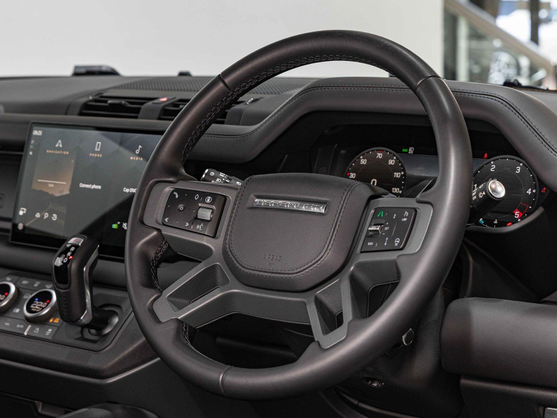 An interior shot of the steering wheel on a 2025 Land Rover Defender 90